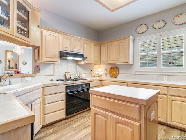 6 Oakwell Farms, San Antonio, TX 78218 - kitchen with light brown cabinetry, black appliances, under cabinet range hood, a sink, and light countertops