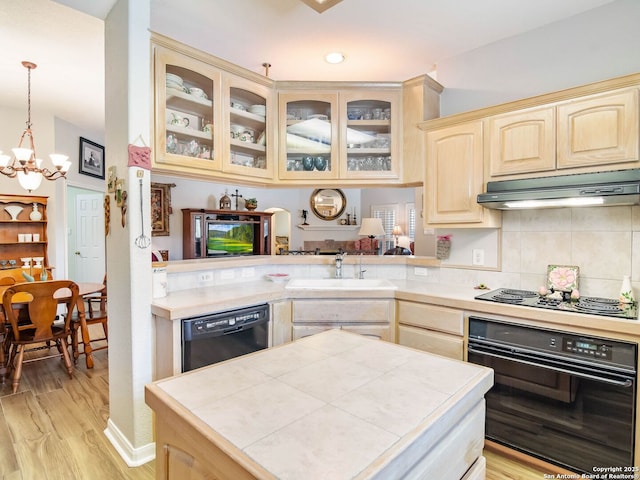 6 Oakwell Farms, San Antonio, TX 78218 - kitchen featuring black appliances, under cabinet range hood, light brown cabinets, a sink, and a chandelier