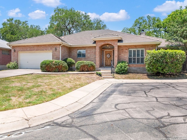 6 Oakwell Farms, San Antonio, TX 78218 - view of front facade with a tile roof, brick siding, concrete driveway, a garage, and a chimney