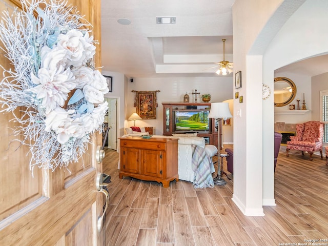 6 Oakwell Farms, San Antonio, TX 78218 - foyer entrance featuring light wood-type flooring, a ceiling fan, arched walkways, a raised ceiling, and baseboards