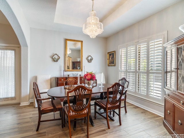 6 Oakwell Farms, San Antonio, TX 78218 - dining area with arched walkways, a chandelier, light wood finished floors, and baseboards