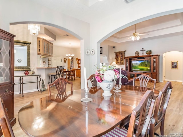 6 Oakwell Farms, San Antonio, TX 78218 - dining space featuring arched walkways, light wood-type flooring, a ceiling fan, baseboards, and a chandelier