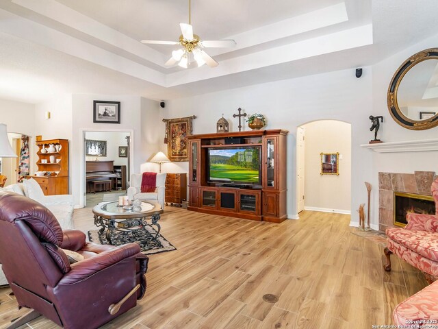 6 Oakwell Farms, San Antonio, TX 78218 - living area with a tray ceiling, arched walkways, ceiling fan, light wood-style floors, and baseboards