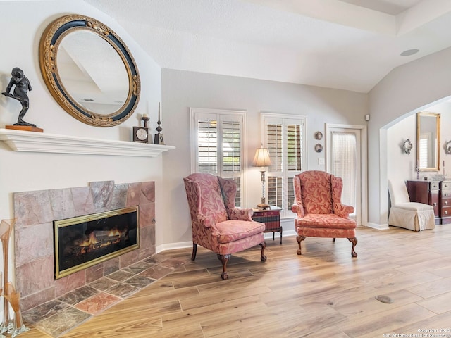 6 Oakwell Farms, San Antonio, TX 78218 - living area featuring wood finished floors, a tiled fireplace, and vaulted ceiling
