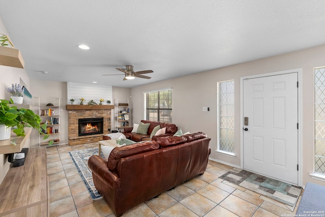 7306 Park W, San Antonio, TX 78250 - living area featuring a ceiling fan, light tile patterned floors, recessed lighting, a fireplace, and a textured ceiling