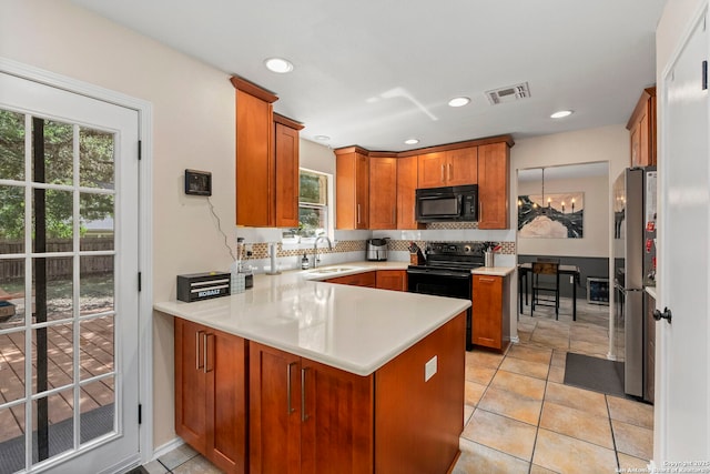 7306 Park W, San Antonio, TX 78250 - kitchen with black appliances, a sink, a peninsula, tasteful backsplash, and light countertops