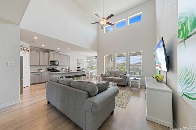 112 La Cima, Boerne, TX 78006 - living area with light wood-style flooring, ceiling fan, healthy amount of natural light, a towering ceiling, and a chandelier