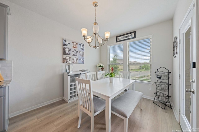 112 La Cima, Boerne, TX 78006 - dining room with a chandelier, light wood-style flooring, and baseboards