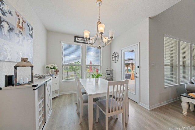 112 La Cima, Boerne, TX 78006 - dining area featuring a chandelier, light wood-style flooring, and baseboards