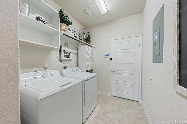 112 La Cima, Boerne, TX 78006 - laundry room with washer and dryer, electric panel, light tile patterned floors, and baseboards
