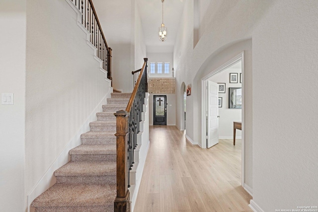 112 La Cima, Boerne, TX 78006 - entrance foyer featuring stairs, light wood-type flooring, a high ceiling, and a chandelier