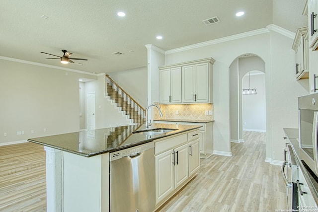 12902 Gypsophila, San Antonio, TX 78253 - kitchen with stainless steel dishwasher, a sink, a ceiling fan, light wood-style flooring, and arched walkways