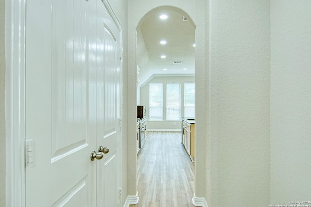 12902 Gypsophila, San Antonio, TX 78253 - hallway with recessed lighting, light wood-type flooring, arched walkways, baseboards, and a textured wall