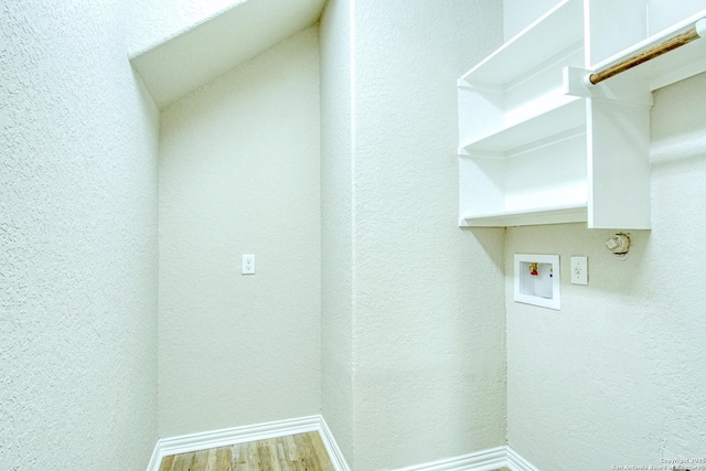 12902 Gypsophila, San Antonio, TX 78253 - washroom featuring hookup for a washing machine, a textured wall, baseboards, and wood finished floors