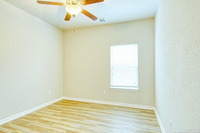 12902 Gypsophila, San Antonio, TX 78253 - unfurnished room with light wood finished floors, baseboards, ceiling fan, and a textured wall