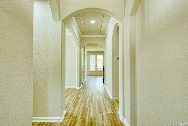 12902 Gypsophila, San Antonio, TX 78253 - corridor featuring a textured wall, arched walkways, crown molding, light wood-type flooring, and baseboards