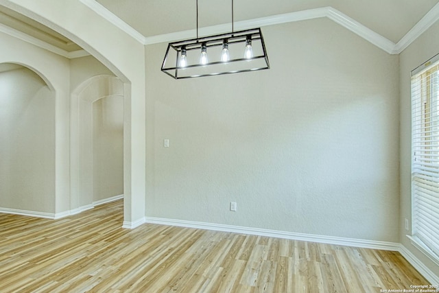 12902 Gypsophila, San Antonio, TX 78253 - unfurnished dining area with wood finished floors, arched walkways, baseboards, crown molding, and lofted ceiling