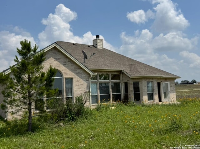 135 Muirfield Ln, Vernia, TX 78121 - rear view of property featuring brick siding, a chimney, and a shingled roof
