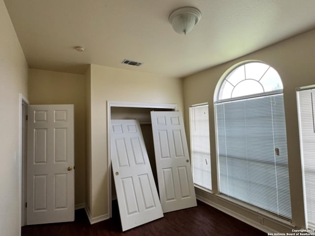 135 Muirfield Ln, Vernia, TX 78121 - unfurnished bedroom with dark wood-style floors and baseboards