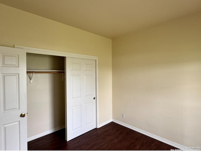 135 Muirfield Ln, Vernia, TX 78121 - unfurnished bedroom with dark wood-type flooring, baseboards, and a closet
