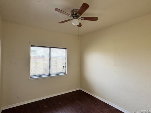 135 Muirfield Ln, Vernia, TX 78121 - empty room featuring dark wood-style flooring, baseboards, and a ceiling fan