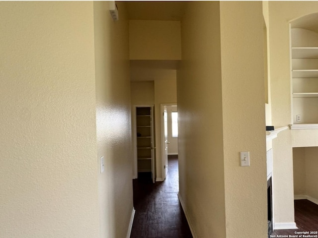 135 Muirfield Ln, Vernia, TX 78121 - corridor with dark wood finished floors, a textured wall, and baseboards