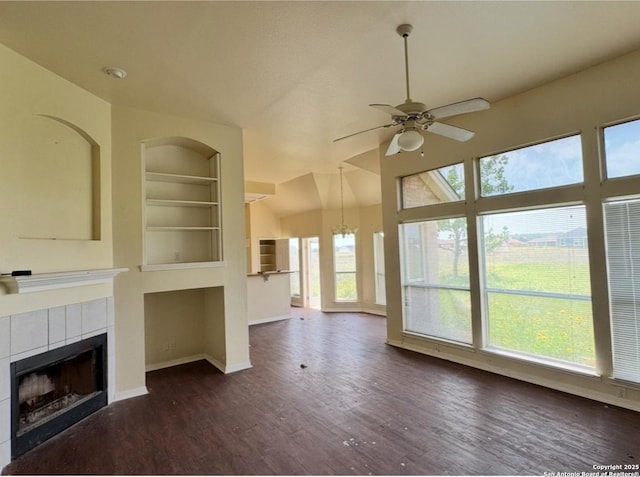 135 Muirfield Ln, Vernia, TX 78121 - unfurnished living room featuring a tiled fireplace, a ceiling fan, wood finished floors, baseboards, and built in shelves