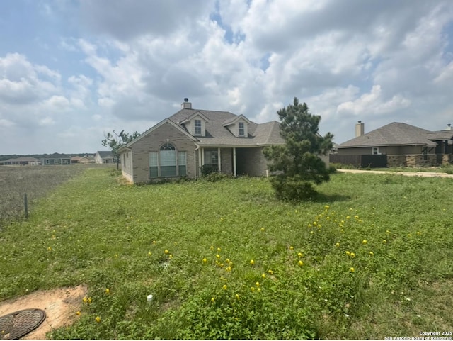 135 Muirfield Ln, Vernia, TX 78121 - view of front of house with brick siding and a chimney