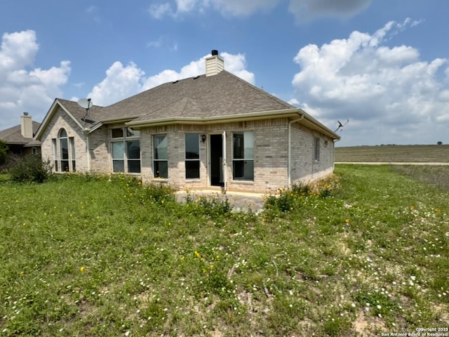 135 Muirfield Ln, Vernia, TX 78121 - back of house featuring brick siding, a chimney, and roof with shingles