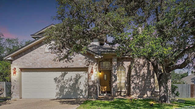 17915 Crystal Knl, San Antonio, TX 78258 - view of front of home with a garage, brick siding, and concrete driveway