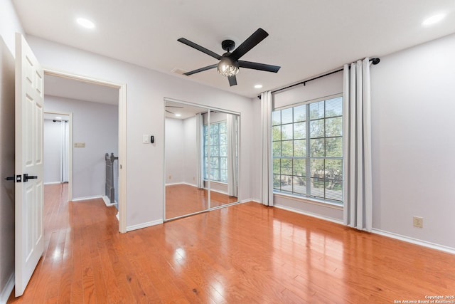 17915 Crystal Knl, San Antonio, TX 78258 - unfurnished bedroom with wood finished floors, baseboards, recessed lighting, a ceiling fan, and a closet