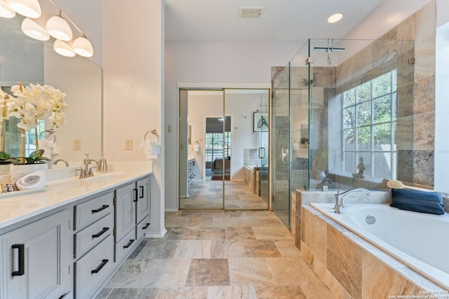 17915 Crystal Knl, San Antonio, TX 78258 - full bathroom with double vanity, stone tile flooring, a garden tub, and a shower stall