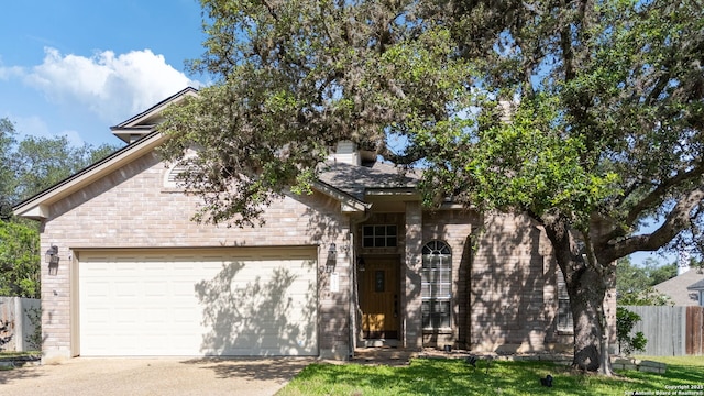 17915 Crystal Knl, San Antonio, TX 78258 - view of front of home with an attached garage, brick siding, and concrete driveway