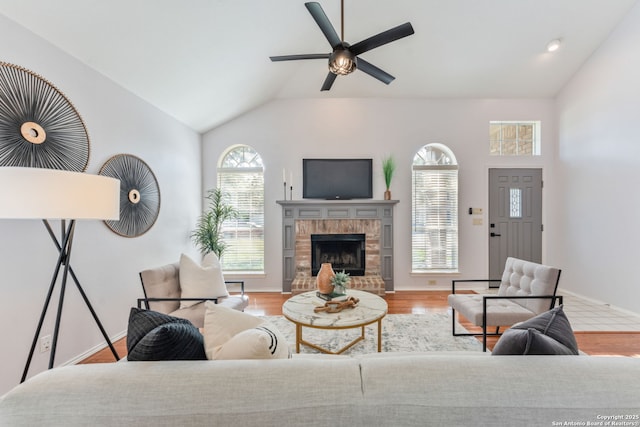 17915 Crystal Knl, San Antonio, TX 78258 - living area with lofted ceiling, ceiling fan, wood finished floors, and a fireplace