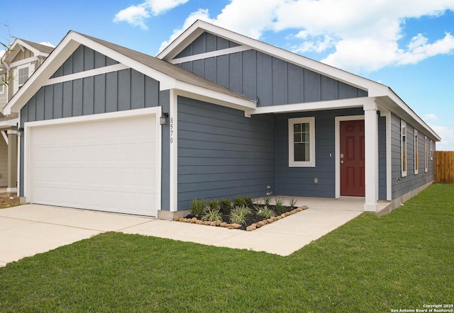 8570 Redhawk Lp, San Antonio, TX 78222 - view of front of house featuring board and batten siding, an attached garage, a front lawn, and concrete driveway