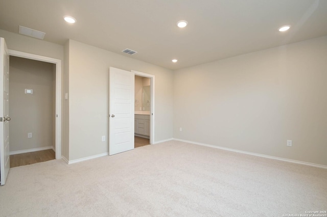 8570 Redhawk Lp, San Antonio, TX 78222 - unfurnished bedroom featuring light carpet, baseboards, recessed lighting, and ensuite bath