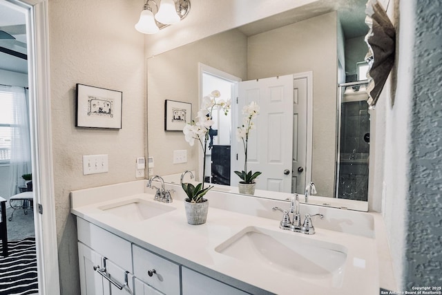 158 Landing Ln, New Braunfels, TX 78130 - ensuite bathroom featuring a textured wall and double vanity
