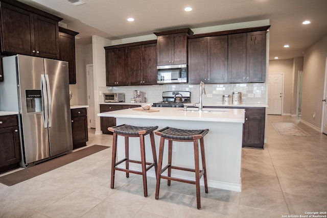 158 Landing Ln, New Braunfels, TX 78130 - kitchen featuring appliances with stainless steel finishes, a sink, tasteful backsplash, light countertops, and recessed lighting