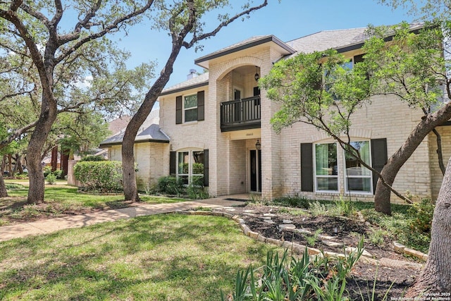 15643 Cloud Top, San Antonio, TX 78248 - view of front facade featuring a balcony, brick siding, and a front lawn