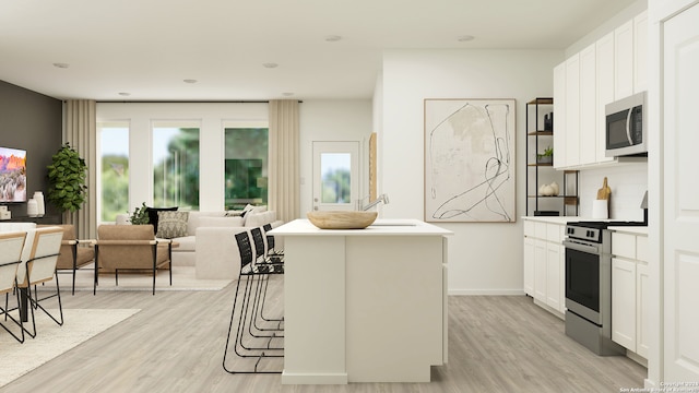 9315 Dassler Spgs, Converse, TX 78109 - kitchen with stainless steel appliances, light wood finished floors, white cabinetry, a center island, and a sink