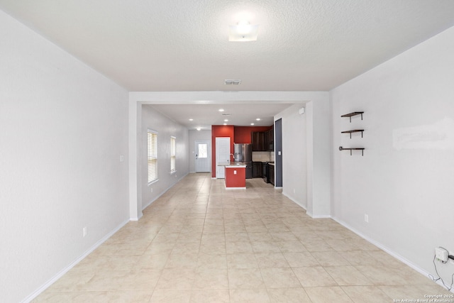 148 Whitetail, San Antonio, TX 78253 - unfurnished living room featuring baseboards and a textured ceiling