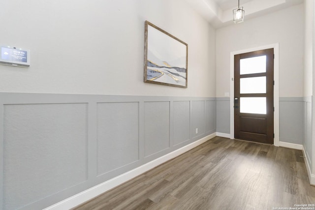 146 Beaver Bnd, Boerne, TX 78006 - foyer with wood finished floors, a wainscoted wall, and a decorative wall
