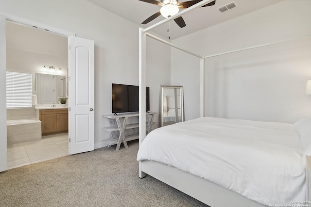146 Beaver Bnd, Boerne, TX 78006 - bedroom featuring light carpet, ensuite bathroom, a ceiling fan, and light tile patterned floors
