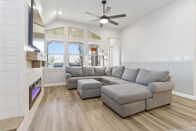 146 Beaver Bnd, Boerne, TX 78006 - living area featuring a ceiling fan, light wood-style flooring, a large fireplace, vaulted ceiling, and baseboards
