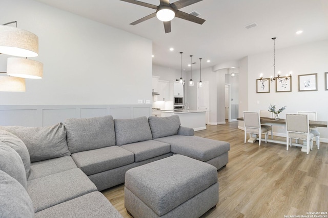 146 Beaver Bnd, Boerne, TX 78006 - living room featuring ceiling fan, a chandelier, light wood finished floors, and recessed lighting
