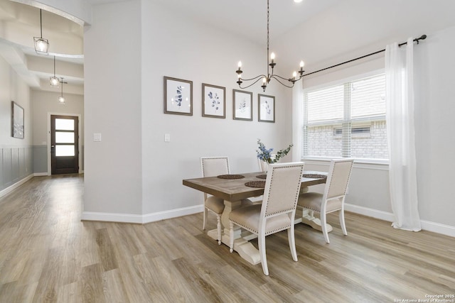 146 Beaver Bnd, Boerne, TX 78006 - dining room with light wood finished floors, a chandelier, and baseboards