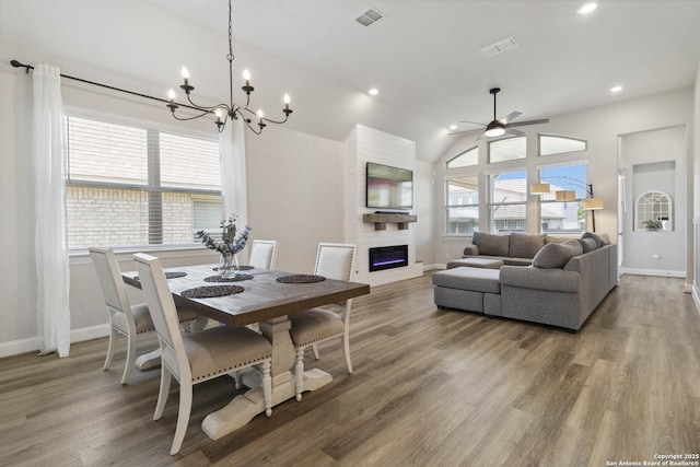 146 Beaver Bnd, Boerne, TX 78006 - dining room with a fireplace, baseboards, ceiling fan, wood finished floors, and lofted ceiling