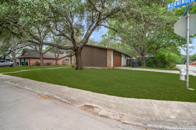 3202 Morning Crk, San Antonio, TX 78247 - view of front of home featuring concrete driveway, a front yard, an attached garage, and brick siding