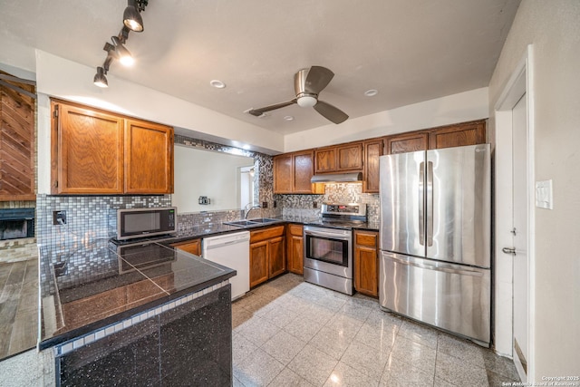 3202 Morning Crk, San Antonio, TX 78247 - kitchen with appliances with stainless steel finishes, tile counters, granite tiled floors, brown cabinets, and under cabinet range hood