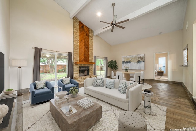 3202 Morning Crk, San Antonio, TX 78247 - living room with high vaulted ceiling, ceiling fan, a stone fireplace, wood finished floors, and baseboards